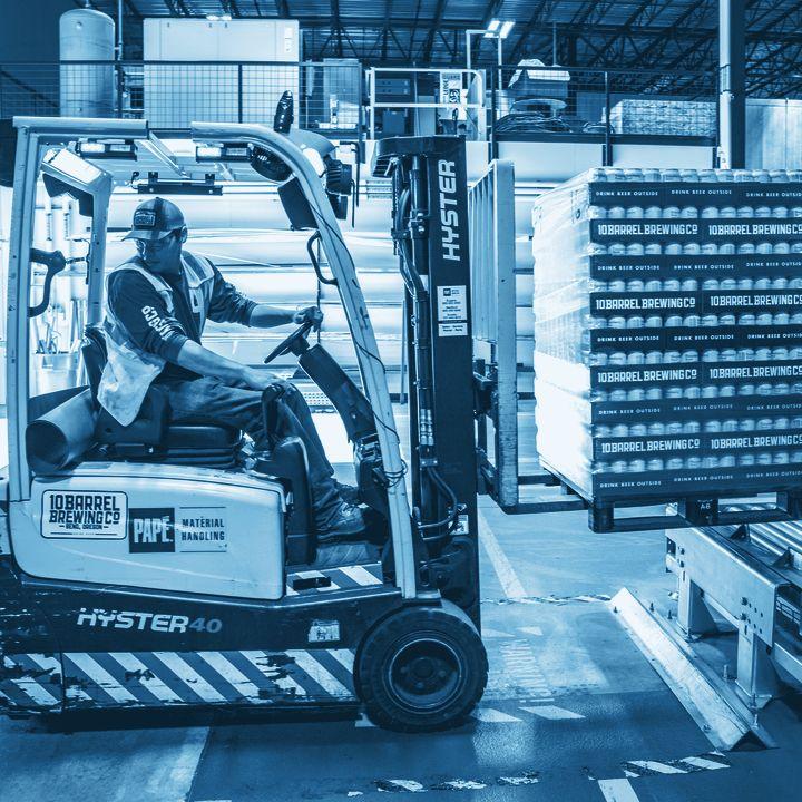 Operator moving a pallet through a distribution centre