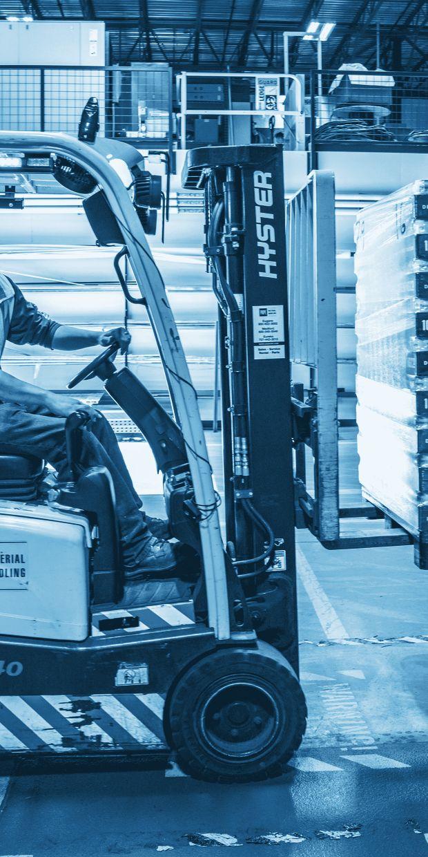 Operator moving a pallet through a distribution centre